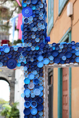 religion and ecology. Cross on a religious holiday made of plastic tubes close up