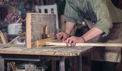 a man working with wood product on the machine