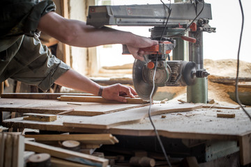 a man working with wood product on the machine