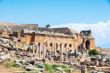 Fototapeta na wymiar Ruins and old buildings in Hierapolis ancient city adjacent to modern Pamukkale in Turkey