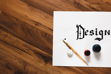 Ink calligraphy design wooden background top view. Work with inks. Painter workshop, business inspiration, creativity, drawing school concept