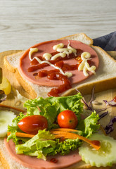 Sandwiches with vegetables salad on wood background.