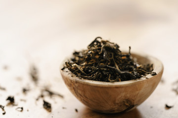 golden orchid tea in small bowl on wood table