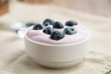 organic blueberry yogurt in bowl on table