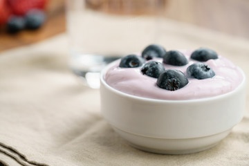 organic blueberry yogurt in bowl on table