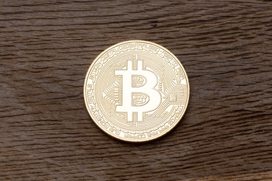 Digital currency physical gold bitcoin on the wood.