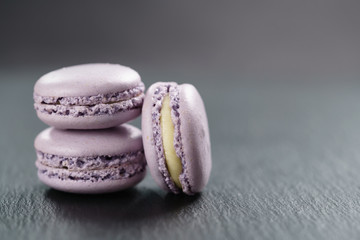 lavender purple macarons stacked on slate board