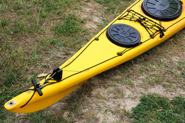 Yellow kayak standing on the beach. Equipment for water sports. Kayaking