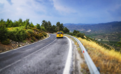 Road and yellow car top view with tilt shift effect.