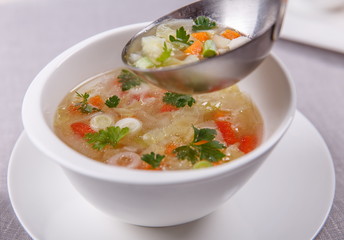 Fresh vegetable soup made of cabbage, carrot, potato, red bell p