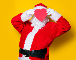 Santa Claus holding heart shape gift