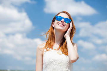 redhead girl in blue sunglasses