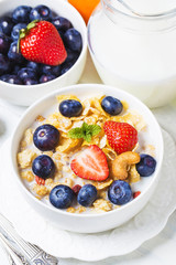 crunchy flakes with blueberries and various yogurts for healthy breakfast, close-up