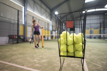Couple collects balls with tube after paddle class to continue training
