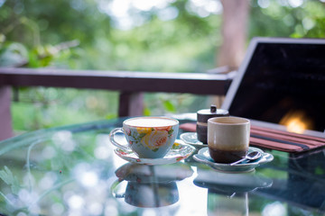 Cup of hot drink with coffee on table.