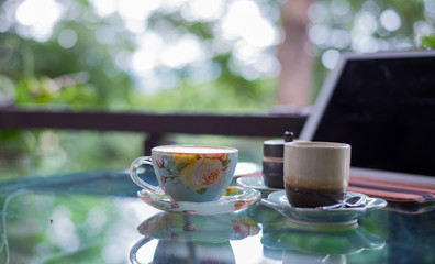 Beautiful cup of hot drink with coffee in coffee shop.