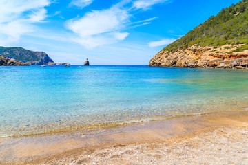 Fototapeta na wymiar View of Cala Benirras beach with azure blue sea water, Ibiza island, Spain
