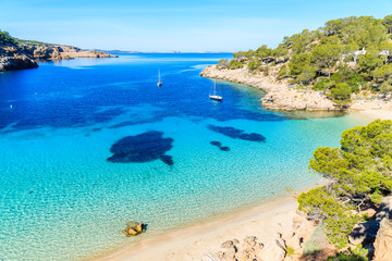 View of beautiful beach in Cala Salada famous for its azure crystal clear sea water, Ibiza island,...