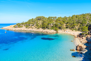 View of beautiful beach in Cala Salada famous for its azure crystal clear sea water, Ibiza island, Spain