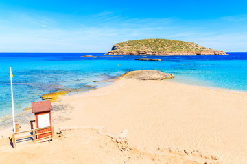 Fototapeta na wymiar Lifeguard tower on beautiful Cala Comte beach famous for its azure crystal clear shallow sea water, Ibiza island, Spain