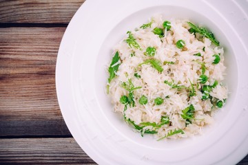 Homemade risotto with chicken, green peas, arugula and parmesan