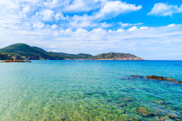 Turquoise sea water on coast of Ibiza island in Es Figueral bay, Spain