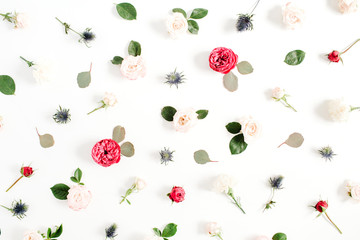 Flower pattern made of red and beige roses, green leaves, branches on white background. Flat lay, top view. Valentine's background. Pattern of flowers. Floral texture.