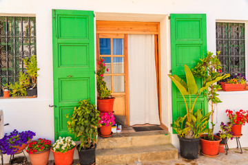 Fototapeta na wymiar Flower pots in front of typical house in Sant Joan de Labritja village, Ibiza island, Spain