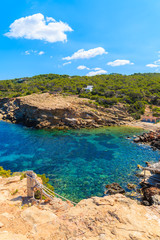 Blue sea water of Punta Galera bay surrounded by amazing stone formations, Ibiza island, Spain