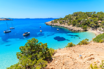 View of beautiful beach in Cala Salada bay famous for its azure crystal clear sea water, Ibiza...