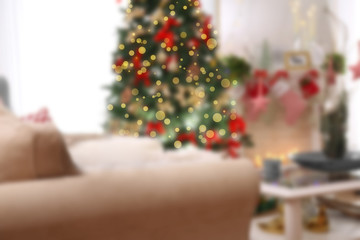 Tabby cat on sofa in beautiful living room decorated for Christmas