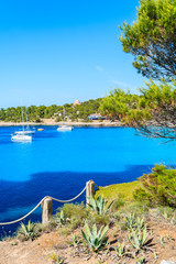 View of beautiful coast of Cala Portinatx bay with azure blue sea water, Ibiza island, Spain