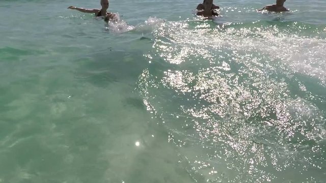 Happy People Group Faving Fun In Water Swimming In Sea On Beach POV, Cheerful Friends Tourists, Young Men And Women Holiday On Summer Sea Vacation