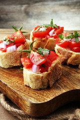 Bruschetta with tomatoes, herbs and oil on toasted garlic cheese bread toasted with chopped tomatoe