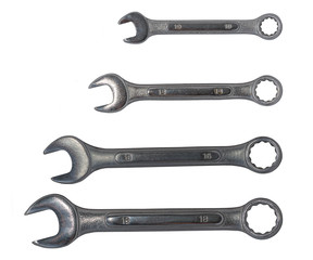 Four spanners of different size on a white background