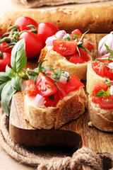 Bruschetta with tomatoes, herbs and oil on toasted garlic cheese