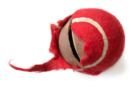 chewed red ball on a white background. dog toy. the concept of Pets