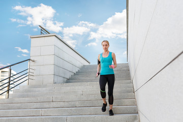 Young fitness healthy woman runner running on city