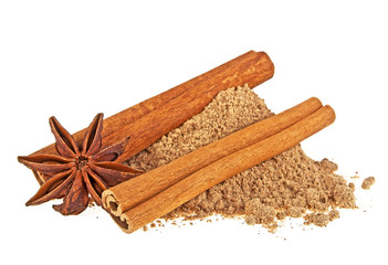 Anise star, cinnamon powder and sticks on white background