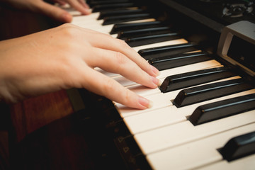 Obraz premium Closeup of young woman playing on piano