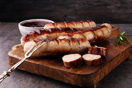 Grilled sausages with sauce ketchup on a wooden table - Home-made Pork Sausages