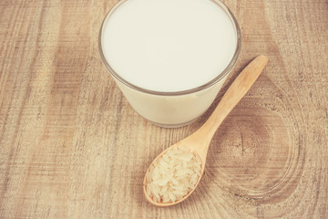 Rice milk on the wooden background .