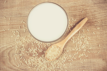 Rice milk on the wooden background .