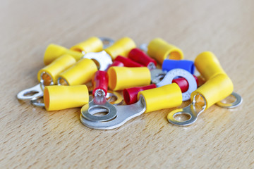 Naklejka premium Colored circular pre-insulated cord ends on the table closeup