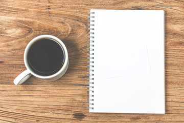 Blank business cards and cup of coffee on wooden table. Corporate stationary branding mock up.