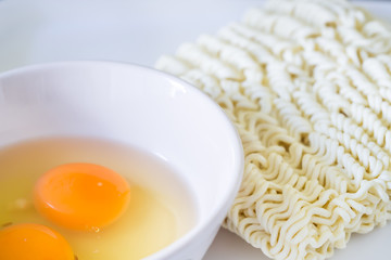 Preparation for cooking instant noodles and eggs.