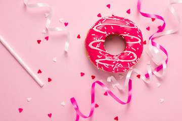 Donuts with icing on pastel pink background with copyspace. Sweet donuts.
