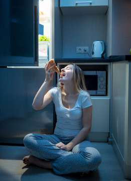 Hungry Woman Eating Pizza On Kitchen Floor At Late Evening