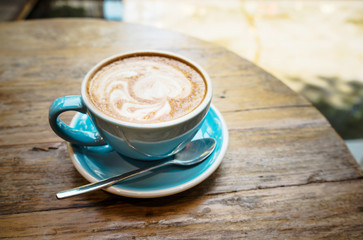  Cup of coffee with latte top view on wooden table/vintage