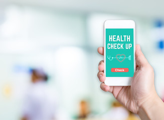 Hand holding mobile  with Health check button and thumb up good or bad results at blur nurse at hospital hallway background bokeh light,Medicare concept.